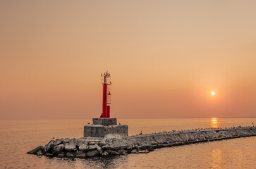 Interesting photo of a small lighthouse in the evening.