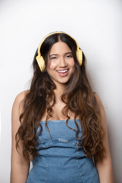 hispanic girl with long straight hair and big headphones