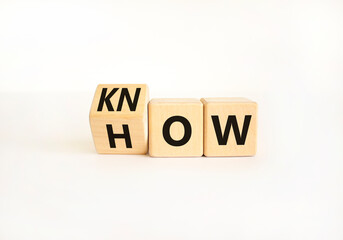 Know how symbol. Businessman turns wooden cubes and changes the word How to Know. Beautiful white table white background. Copy space. Business and know how concept.