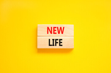 New life symbol. Concept words New life on wooden blocks on a beautiful yellow table yellow background. Business, support, motivation, psychological and new life concept. Copy space.