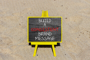 Consistent brand message symbol. Concept words build a consistent brand message on beautiful black chalkboard. Beautiful sand beach background. Business consistent brand message concept. Copy space.