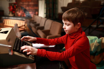 Child studying retro typewriter
