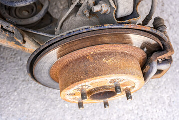 Worn used car brake disk close up. Changing wheels and brakes.