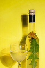 dandelion wine, on a yellow background