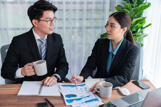 Busy analyst team in office discuss data analysis and marketing strategy using BI dashboard and statistics to improve business performance at corporate meeting with successful teamwork. Jubilant