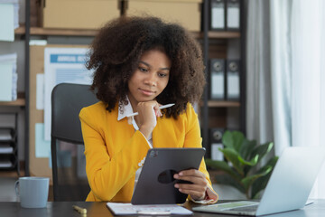 African American businesswoman using digital tablet at office workplace.
