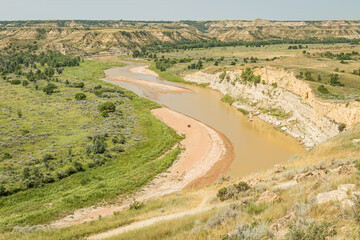 Fototapeta na wymiar Bend in the muddy waters of the Little Missouri River from a bluff in the Norther Great Plains of Theordore Roosevelt National Park North Dakota 
