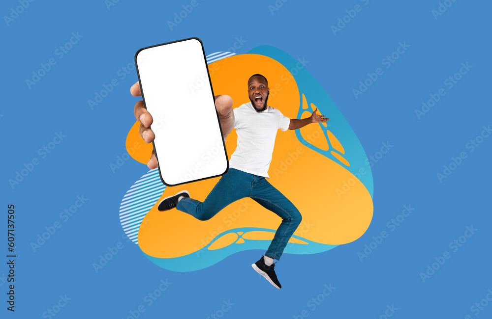 Poster Excited black guy showing empty smartphone screen while jumping over colorful background