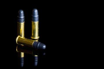 Three small caliber .22 bullets. - obrazy, fototapety, plakaty