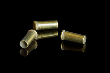 Three empty cartridges of small caliber bullets.
