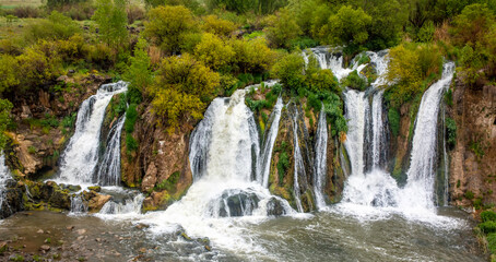 Fototapeta na wymiar Muradiye waterfall, located on the Van - Doğubeyazıt highway, is a natural wonder that is frequently visited by tourists in Van.