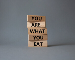 You are what you Eat symbol. Concept words You are what you Eat on wooden blocks. Beautiful grey background. Healthy eating and You are what you Eat concept. Copy space.