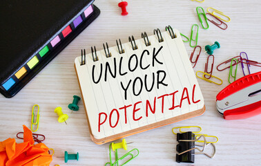 Unlock your Potential symbol. Concept words Unlock your Potential on white notebook. Beautiful wooden background. Business and Unlock your Potential concept. Copy space.