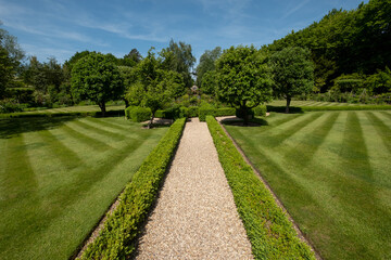 Flower borders in a landscaped garden in Hartley Wintney, Hampshire, UK
