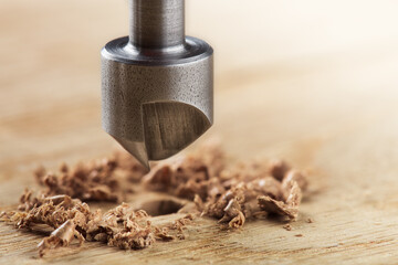 Countersink drill bit with steel triangle ruler make sink in hole for screw in wooden oak plank