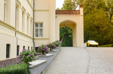 Exquisite Country House with Columns: Front Facade and Parked Yellow Porsche