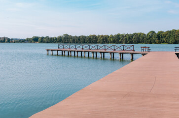 Sunny Day by the Lake or River: Landscape with Ducks Swimming, Boat Dock, and a Leisure Pier