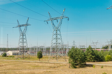 Row of High Voltage Power Poles in a White Day Field