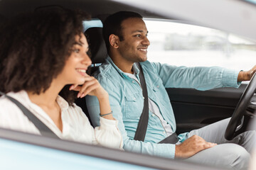 Arabic couple driving sharing road adventure experiences sitting in car