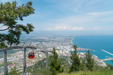 Panoramic view to Antalya city, sea and cable road Tunektepe from the mountain, Turkey