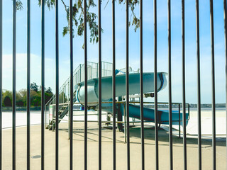 abandoned water slide behind a fence