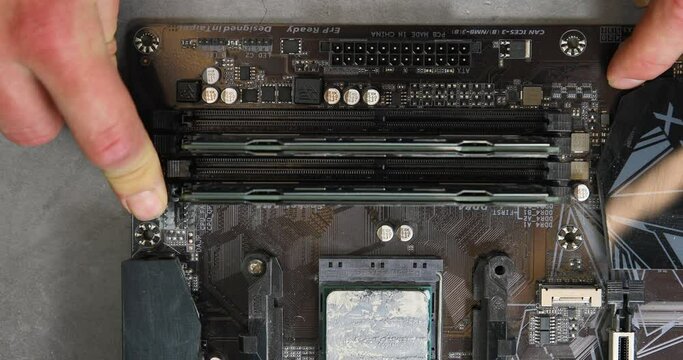 Installing RAM memory into personal computer motherboard 