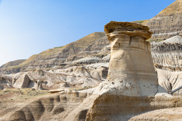 hoodoos with rocky landscape and blue sky in Drumheller Alberta Canada