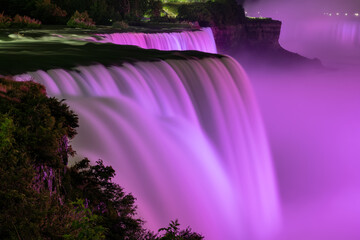 Niagara Falls lit at night by purple lights, Niagara Falls, NY, USA