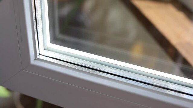 Washing windows. Washing the window frame. Dusting. Home cleanliness care. House cleaning. Horizontal video.