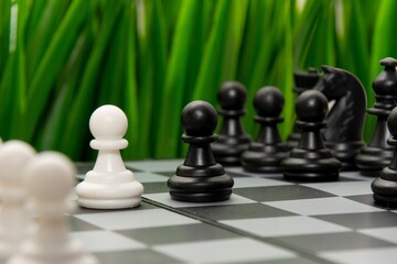 chess game. Black and white chess pawn on the background of a chessboard.The concept of...
