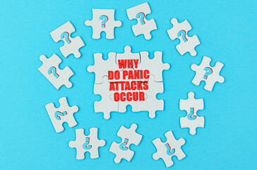 On a blue surface are puzzles with a question mark, in the center with the inscription - why do panic attacks occur