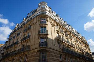 The facade of traditional French house with typical balconies and windows. Paris.