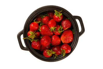 Strawberry fragrant fresh summer clean in a black saucepan isolated on white background