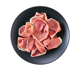 Spanish jamon cut, parma ham cutting in a black plate isolated on white background.