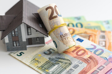 Small house on dollar bills background