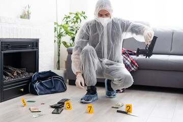 Forensics researcher photographing a blood at a murder scene