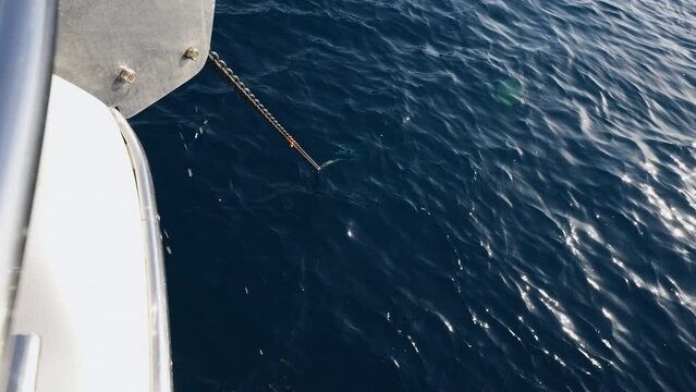 Winding the anchor chain. Moving anchor chain on a yacht or sailboat.