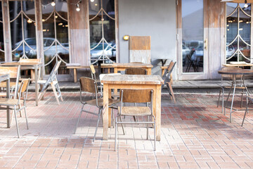 Empty street cafe with terrace with tables and wooden chairs. Street vintage exterior of...