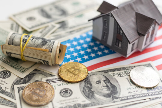 Concept of expenses for new home; small house, dollar paper money.