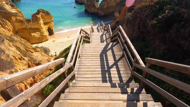 View of idyllic nature landscape with rocky cliff shore and waves crashing on. Camillo beach in Lagos. West Atlantic coast of Algarve region, south of Portugal.