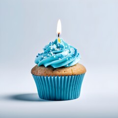 Cupcake with blue icing and sprinkles and birthday candle