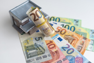 Money dollar and The model of a wooden house. Concept Having a house or buying a home or home loan.
