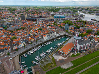 Fototapeta na wymiar This aerial drone photo shows the Marina and harbour of Vlissingen. Vlissingen is a beautiful coastal town in Zeeland, the Netherlands. You can also see a part of the city center and Westerschelde. 