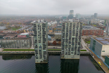 Fototapeta na wymiar Aerial drone photo of two apartment buildings and a lake in Almere, Flevo the Netherlands. 