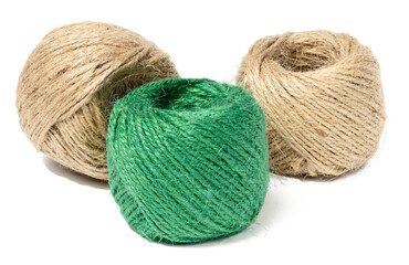 Brown and green skeins of jute rope on a white isolated background