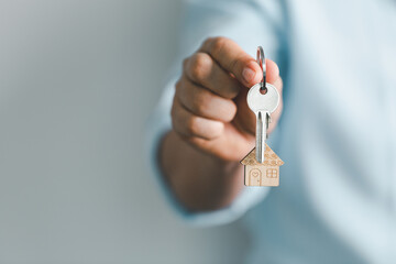 key to your own home in the palm of the girl and a wooden for real estate renting property. House...