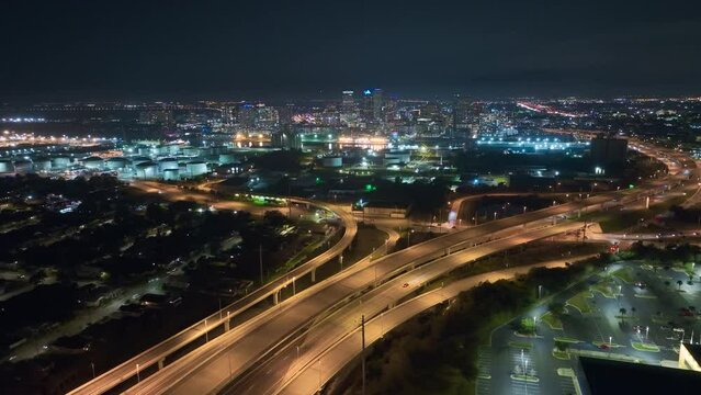 Above view of wide highway crossroads in Tampa, Florida at night with fast driving cars. USA transportation infrastructure concept