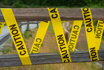 Caution sign tape concept of warning and danger. Yellow CAUTION tape barring exit. Do not enter...