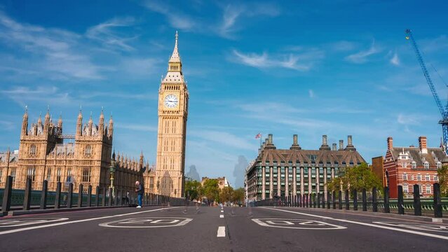 Big Ben clock tower on a sunny early morning in London, UK. A view of the popular London landmark, the clock tower known as Big Ben, showing 3pm as the time set against a blue and cloudy sky.
