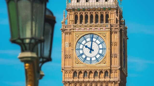 Big Ben clock tower on a sunny early morning in London, UK. A view of the popular London landmark, the clock tower known as Big Ben, showing 3pm as the time set against a blue and cloudy sky.